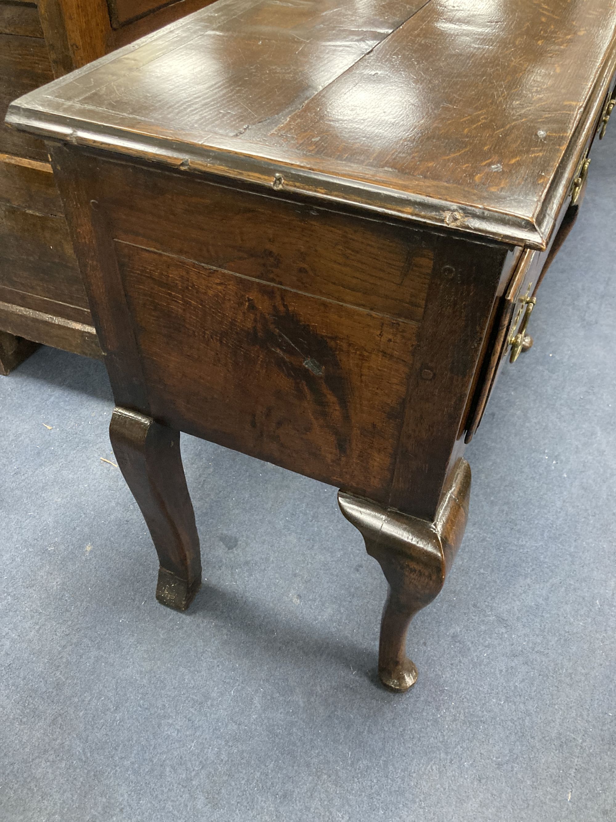 A late 17th century oak dresser base on cabriole front legs, length 180cm, depth 43cm, height 77cm